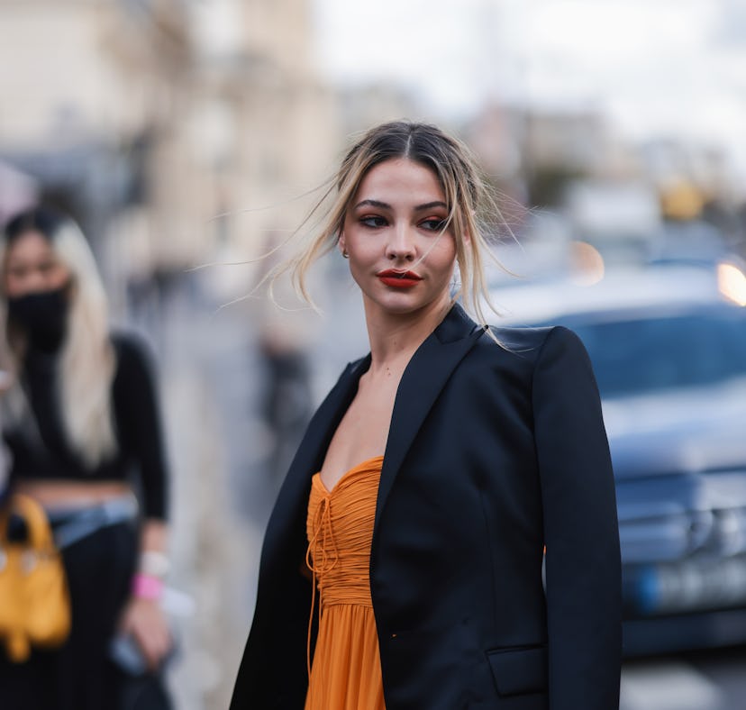 Madelyn Cline, who reignited dating rumors with Ross Butler, wears orange dress and black blazer out...