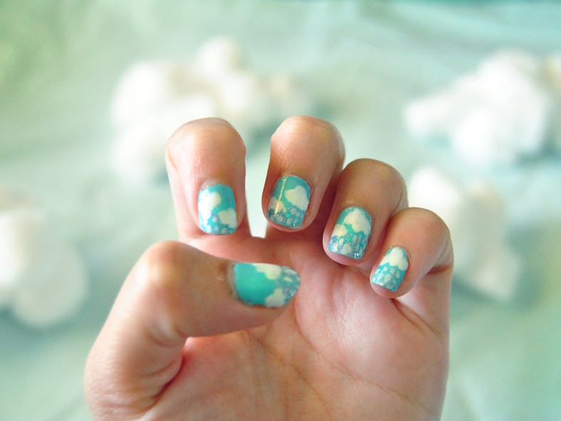 Clouds nail art design with cotton balls as cloud background.