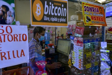SAN SALVADOR, EL SALVADOR - OCTOBER 22: A worker checks out a customer at a store where Bitcoin curr...