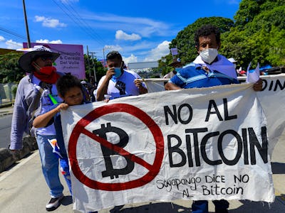 SAN SALVADOR, EL SALVADOR - OCTOBER 17: A demonstrator holds a sign against the approved Bitcoin law...