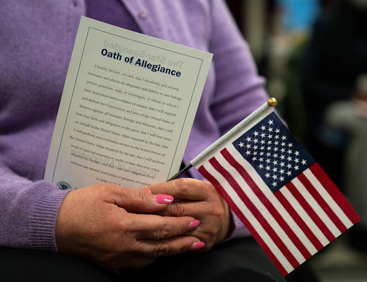 Candidates for U.S. citizenship listen to the presiding official during a 2021 naturalization ceremo...
