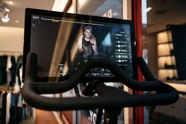 NEW YORK, NY - DECEMBER 04: An instructor is seen on the video display of a Peloton stationary bike ...