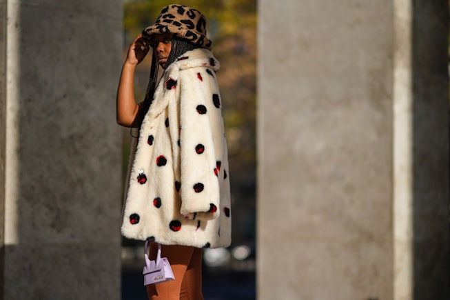 PARIS, FRANCE - NOVEMBER 05: Fatou N'Diaye wears a brown and black fluffy leopard print hat from Aso...