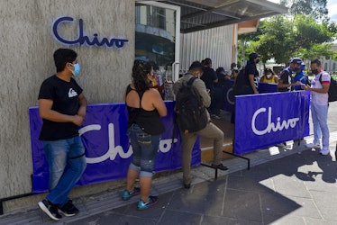 SAN SALVADOR, EL SALVADOR - OCTOBER 21: People wait in line to make a transaction at a Chivo ATM on ...