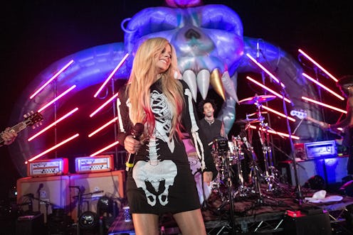 MALIBU, CALIFORNIA - OCTOBER 19: (L-R) Musicians Travis Barker, Avril Lavigne perform onstage during...