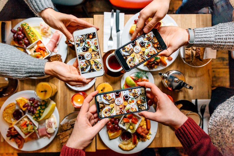 A group of friends take Instagrams of brunch to post in a food photo dump. Here are ideas for food p...