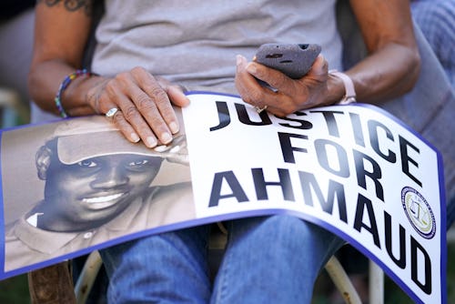 BRUNSWICK, GA - OCTOBER 18: Janice Braggs holds a sign at the Glynn County Courthouse as jury select...