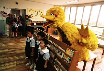 SHANGHAI, CHINA - OCTOBER 1998: School children pose in class for a photo with Big Bird of Sesame St...