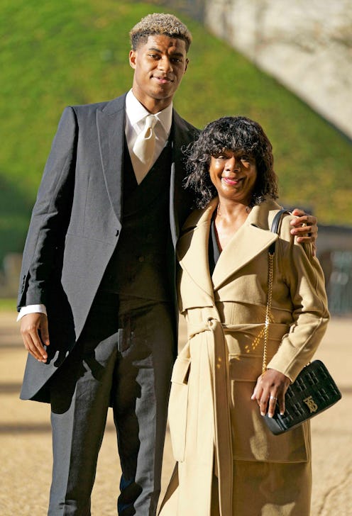 Manchester United and England footballer Marcus Rashford poses his mother Melanie Rashford before be...