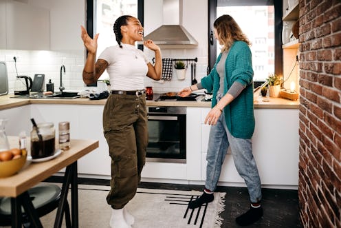 Two women prepare breakfast at home. Financial experts share budgeting hacks for millennials.