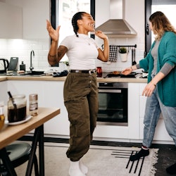 Two women prepare breakfast at home. Financial experts share budgeting hacks for millennials.