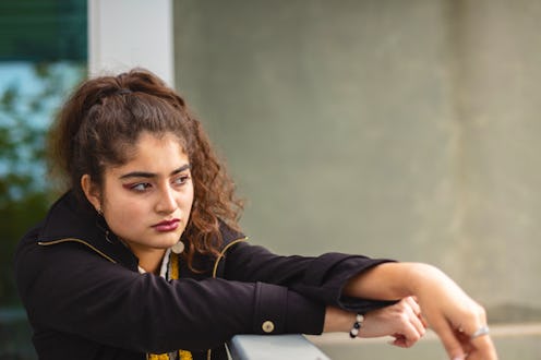 In Western Colorado Generation Z Female of Mexican American Ethnicity on High Rise Balcony Photo Ser...