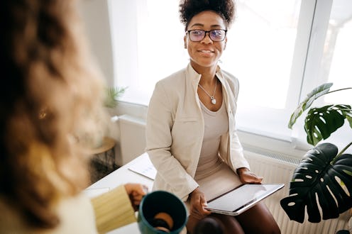 Two business women work in office. They work happily. Team work process. Professional service and cu...