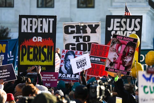 WASHINGTON, DC - DECEMBER 01: Abortion rights advocates demonstrate in front of the Supreme Court of...