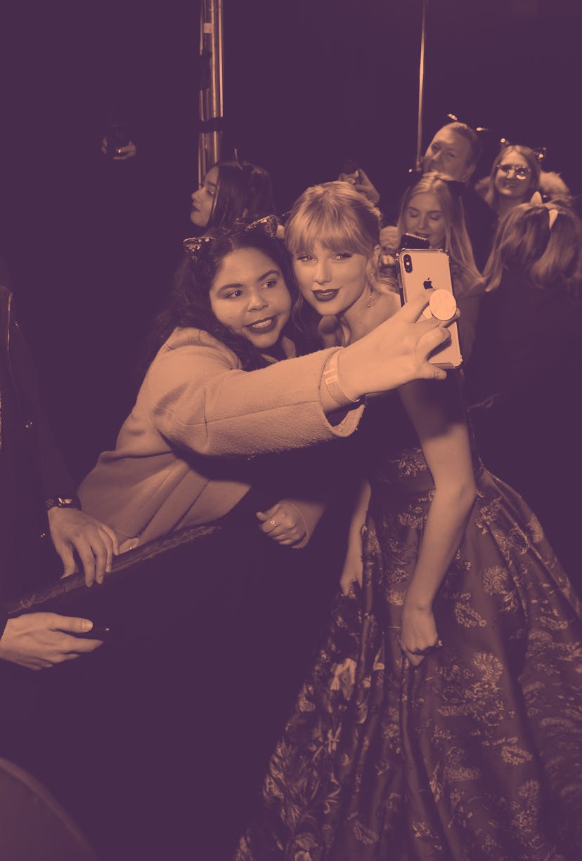 NEW YORK, NEW YORK - DECEMBER 16: Taylor Swift and a fan are seen during The World Premiere of Cats,...