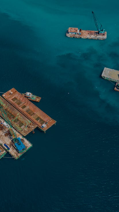 Drone view lighters and crane vessels is nailing on Ca Na sea - Ninh Thuan province, central Vietnam