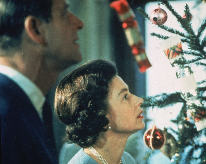 June 1969: Queen Elizabeth II and Prince Philip look at their decorated Christmas tree during the fi...