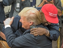 American rapper and producer Kanye West embraces real estate developer and US President Donald Trump...