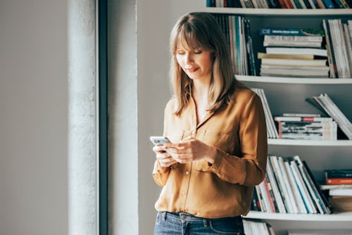 A woman looks at her phone, wondering if she'd been muted on Instagram. Here's how to tell if someon...