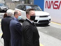 CAPE CANAVERAL, FLORIDA - MAY 27: SpaceX founder Elon Musk (L) wears a face mask as he watches NASA ...