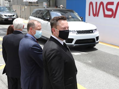 CAPE CANAVERAL, FLORIDA - MAY 27: SpaceX founder Elon Musk (L) wears a face mask as he watches NASA ...