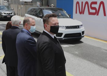 CAPE CANAVERAL, FLORIDA - MAY 27: SpaceX founder Elon Musk (L) wears a face mask as he watches NASA ...