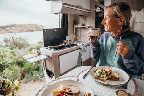 A woman has breakfast in a van. Here's your daily horoscope for december 13, 2021.