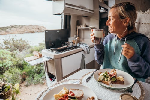 A woman has breakfast in a van. Here's your daily horoscope for december 13, 2021.
