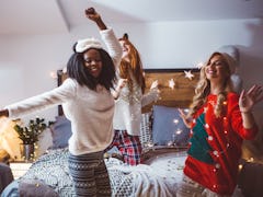 Friends dance listening to the best Christmas song lyrics including holiday albums from Ariana Grand...