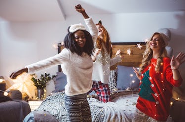 Friends dance listening to the best Christmas song lyrics including holiday albums from Ariana Grand...