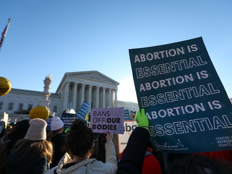 WASHINGTON, DC - DECEMBER 01: Abortion rights advocates demonstrate in front of the Supreme Court of...