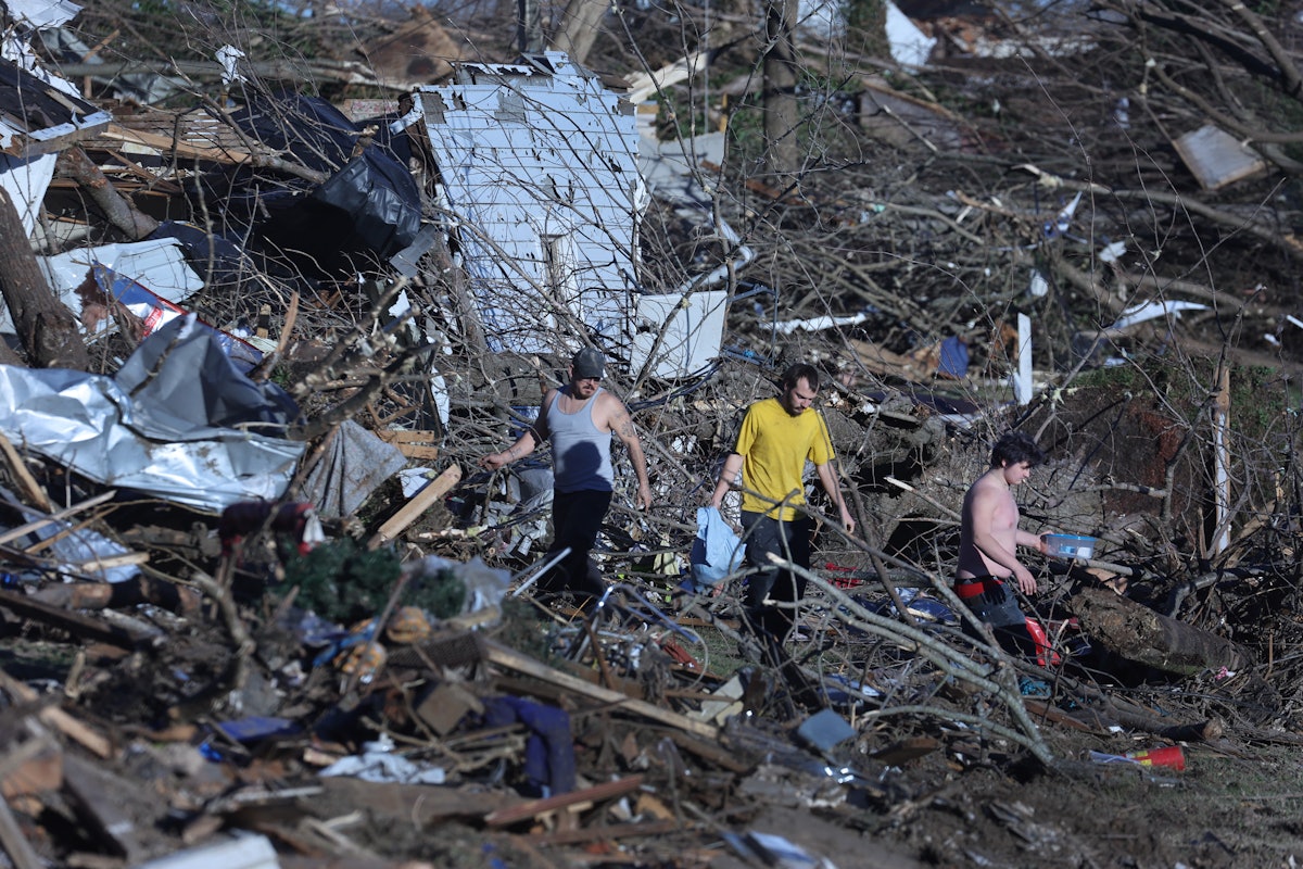 A photo of citizens in Kentucky walking through tornado wreckage. Here's how to help Kentucky tornad...