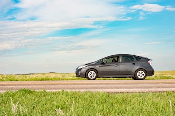By Rapid City, United States a Toyota Prius on a cross country road trip parks by the side of the ro...