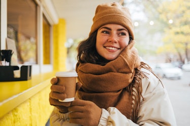 A woman with hot cocoa may want cold puns and cold weather puns to caption winter Instagram posts.