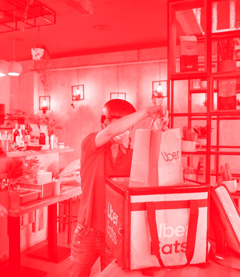 PRODUCTION - 02 September 2021, Berlin: Silvan (r), a driver for food delivery service Uber Eats, pi...