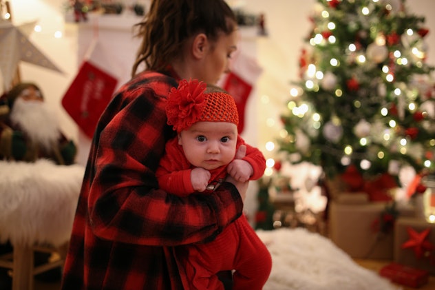 Newborn baby in the arms of her mother. Christmas collection