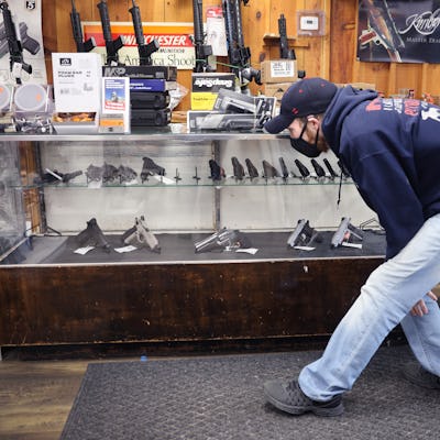 TINLEY PARK, ILLINOIS - APRIL 08: Alexander Carey shops for a new handgun at Freddie Bear Sports on ...