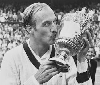 Stan Smith of the United States poses for photographs and kisses the Gentlemen's Singles Trophy foll...
