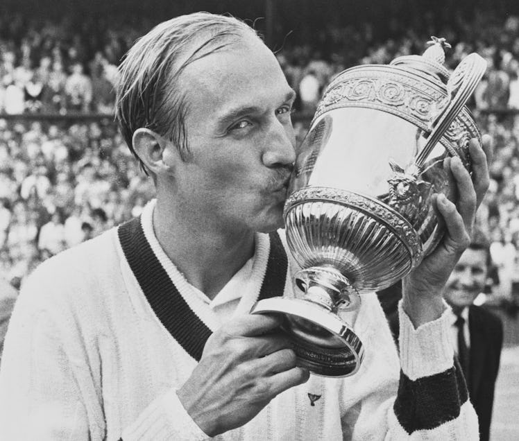 Stan Smith of the United States poses for photographs and kisses the Gentlemen's Singles Trophy foll...