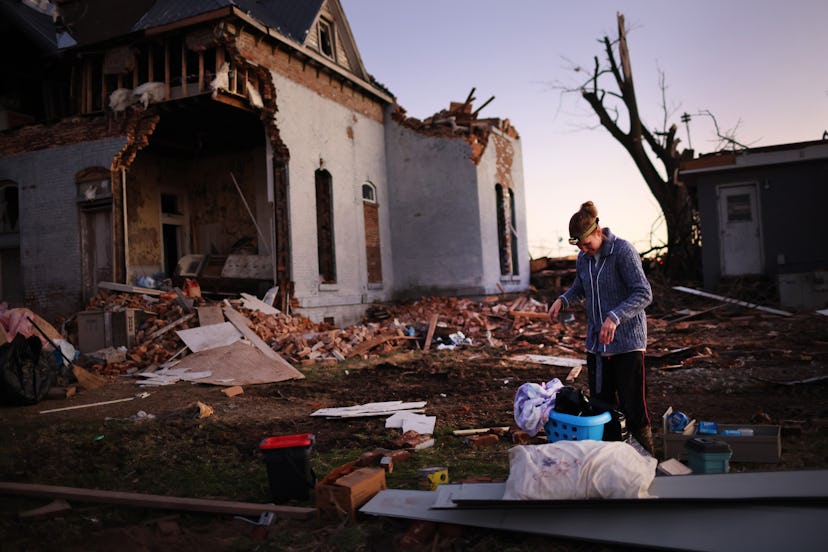 A woman salvages items from a home in Kentucky, where efforts are being made to help tornado victims...