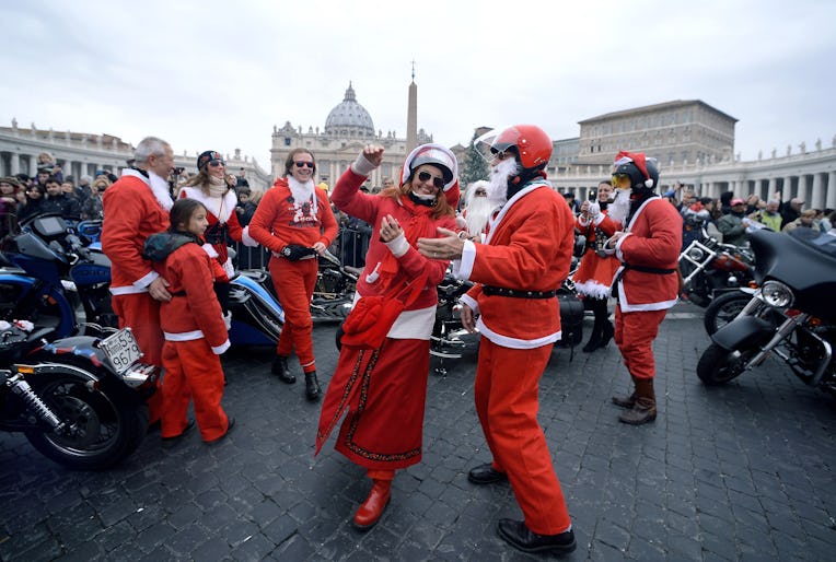 Motorcyclists dressed as Santa Claus dance on Saint Peter's square in the Vatican, as they tour cent...