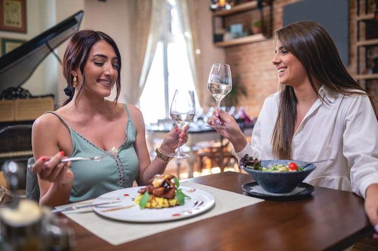 Two sisters drinking wine and eating at an elegant restaurant, which is an idea if you're wondering ...