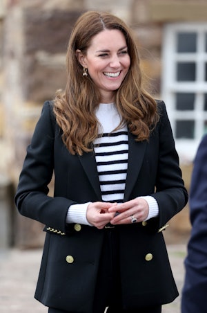 Britain's Catherine, Duchess of Cambridge gestures during a visit to meet local fishermen and their ...