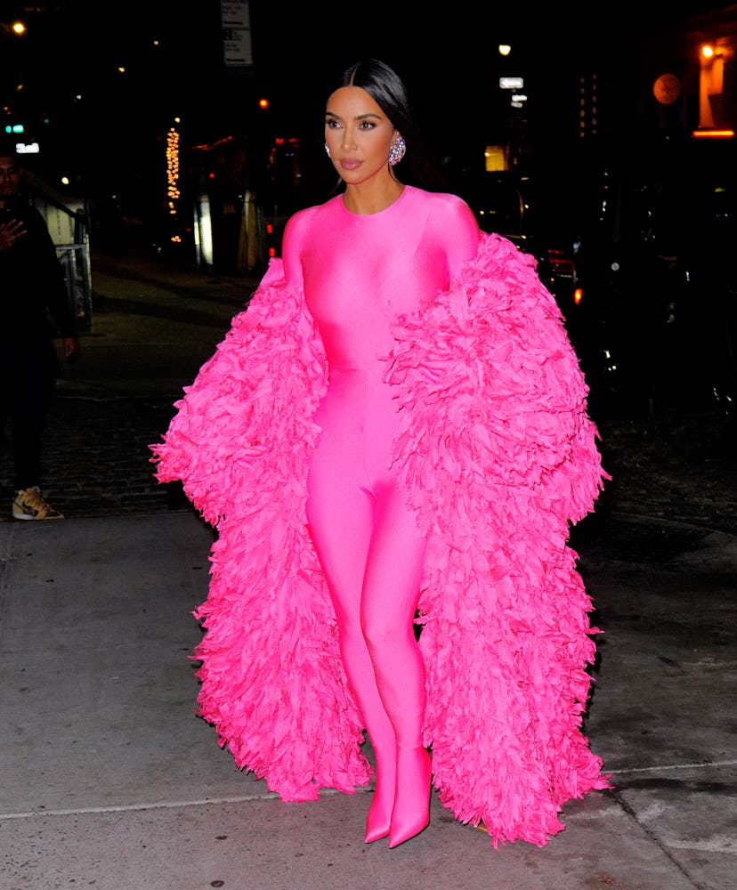 Kim Kardashian wearing a hot pink catsuit.