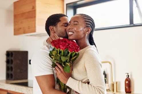 Woman receiving a bouquet of roses from her partner
