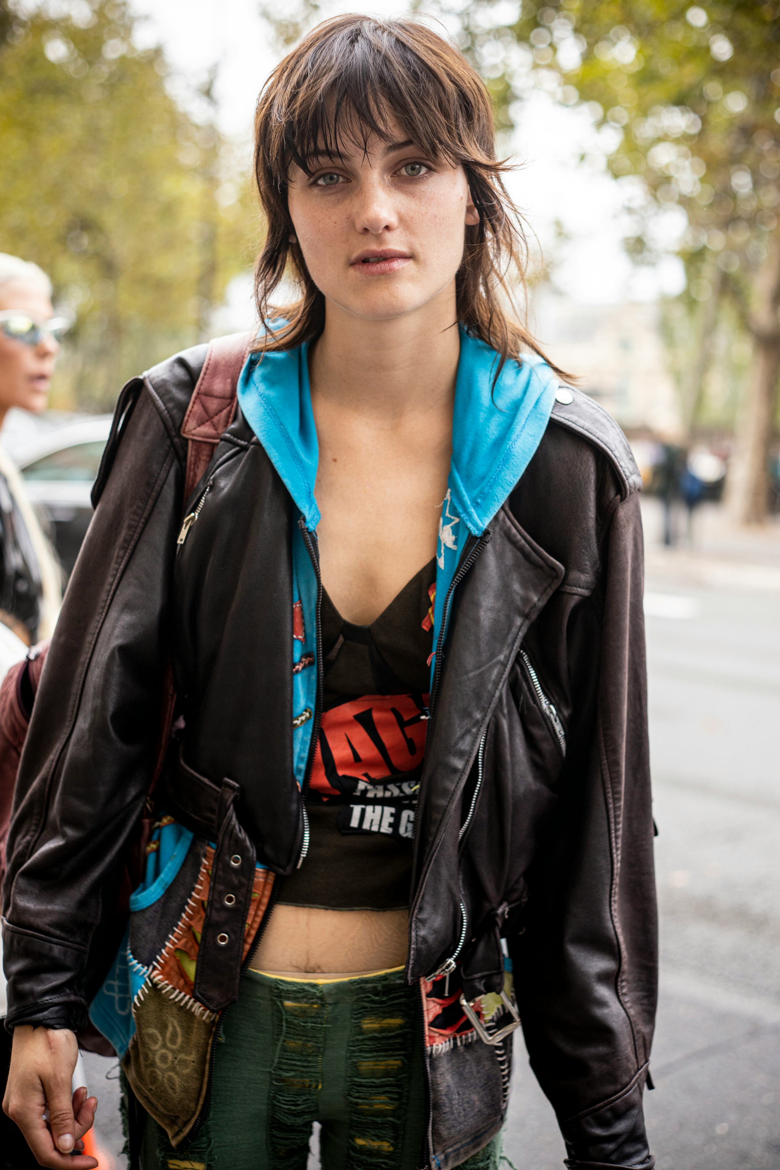 A model with a shag hairdo is seen outside the Unravel show during Paris Fashion Week.