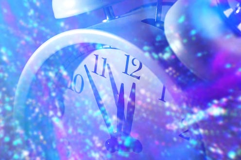 Christmas clock midnight. Alarm clock and a breeze of sparkles and lights in the trendy color of 202...
