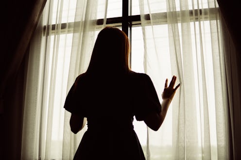 woman silhouette in front of the window