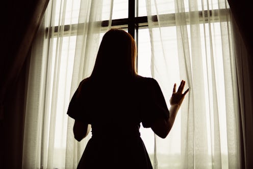 woman silhouette in front of the window