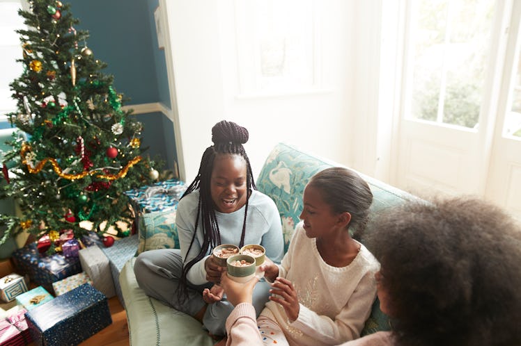 High angle view of sisters toasting spiked hot chocolate, which is a solstice drink. 